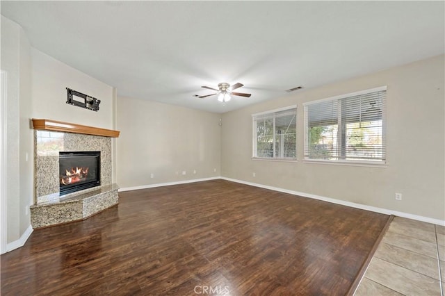 unfurnished living room with ceiling fan and hardwood / wood-style flooring