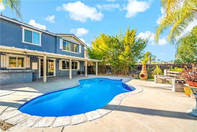 view of pool featuring a bar and a patio area