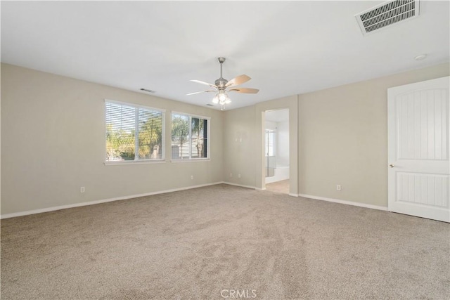 spare room with light carpet and ceiling fan