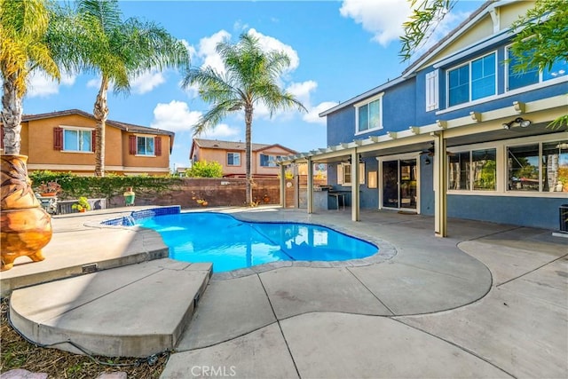 view of pool featuring pool water feature, a pergola, and a patio