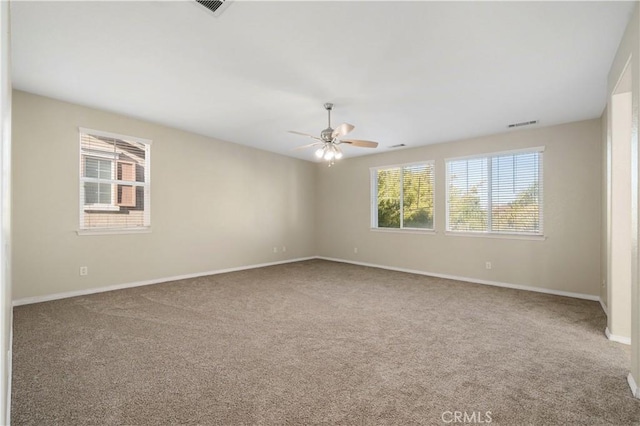 carpeted spare room with ceiling fan