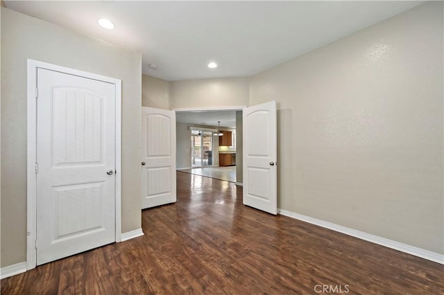 unfurnished room with dark hardwood / wood-style flooring