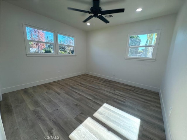 unfurnished room featuring ceiling fan and dark hardwood / wood-style floors