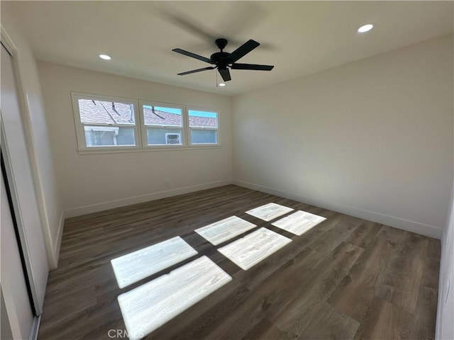 empty room featuring ceiling fan and dark wood-type flooring