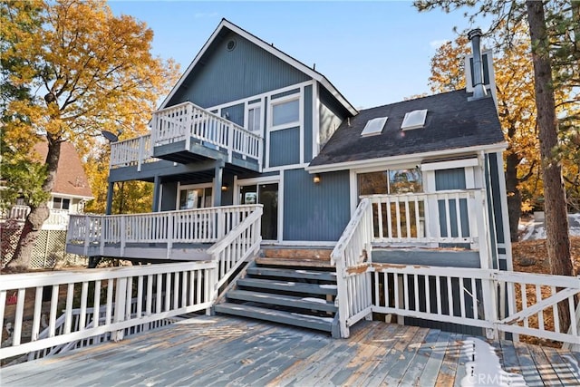 back of house featuring a wooden deck