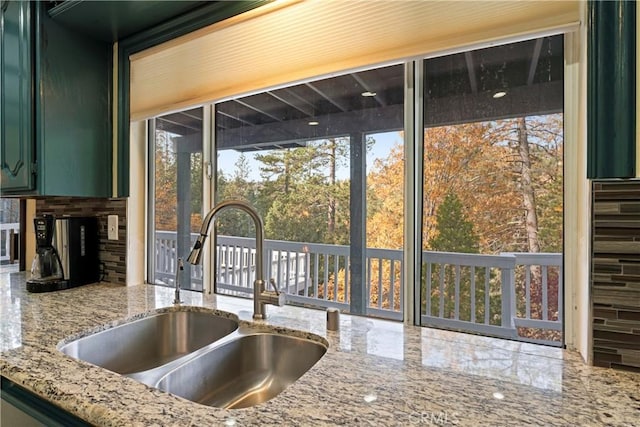 kitchen featuring green cabinets, sink, and a wealth of natural light