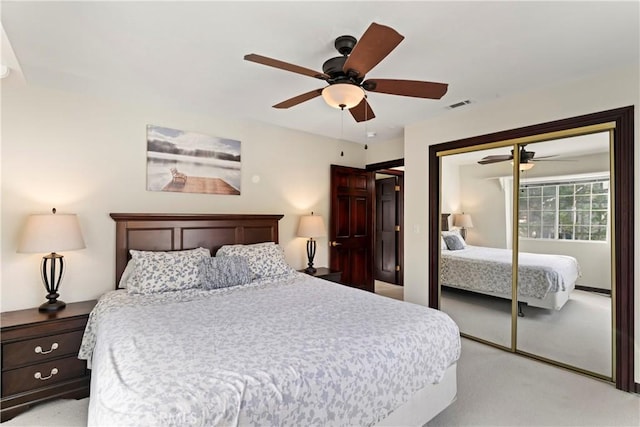 bedroom featuring ceiling fan, a closet, and light carpet