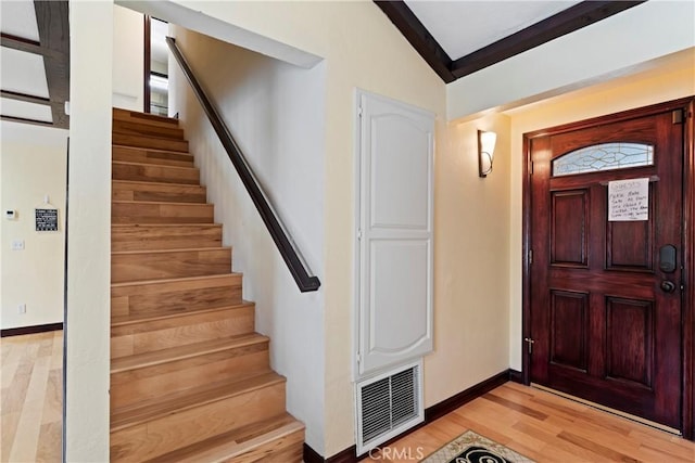 foyer entrance featuring light hardwood / wood-style flooring and lofted ceiling