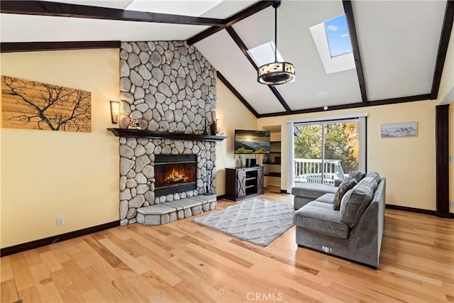 918 Sandalwood Dr, Lake Arrowhead, CA 92352 - living room with a skylight, a fireplace, beamed ceiling, wood finished floors, and high vaulted ceiling