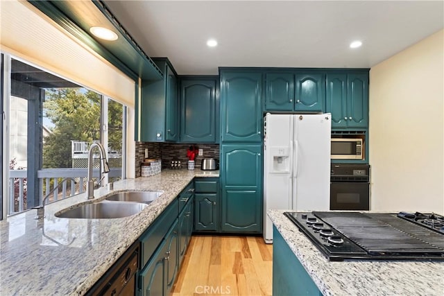 918 Sandalwood Dr, Lake Arrowhead, CA 92352 - kitchen featuring black appliances, light stone countertops, light wood finished floors, recessed lighting, and tasteful backsplash