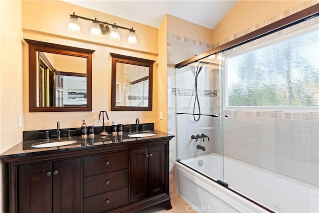 bathroom with vanity, lofted ceiling, and enclosed tub / shower combo