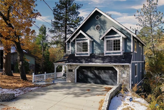 918 Sandalwood Dr, Lake Arrowhead, CA 92352 - view of front facade featuring stone siding, an attached garage, and concrete driveway