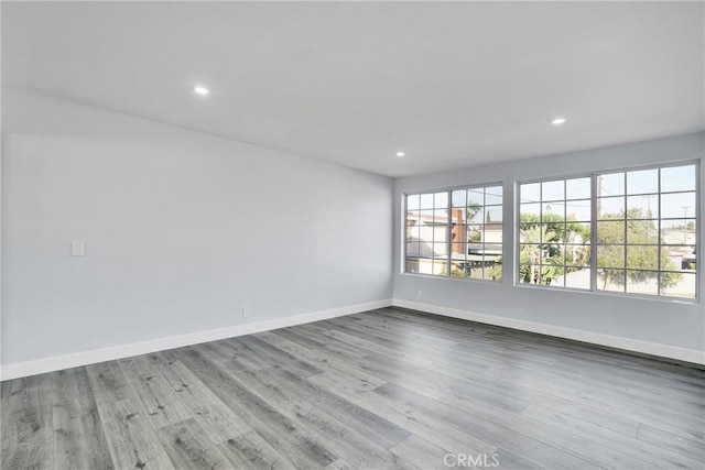 empty room with light hardwood / wood-style flooring