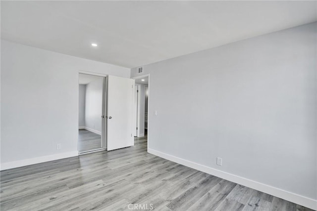 unfurnished room featuring light hardwood / wood-style flooring