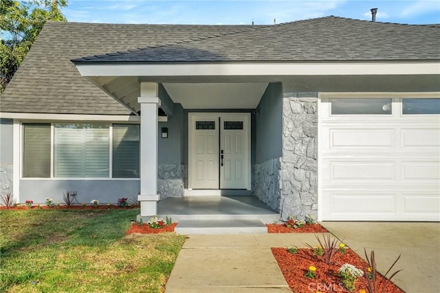 property entrance featuring a lawn and a garage