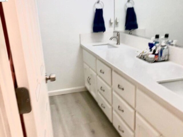 bathroom featuring hardwood / wood-style floors and vanity