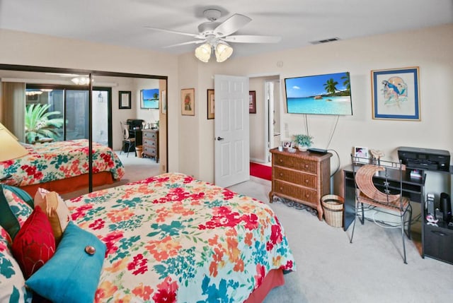 bedroom with ceiling fan, a closet, and light colored carpet