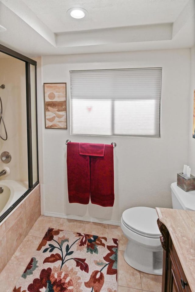 full bathroom featuring shower / bathing tub combination, vanity, tile patterned floors, toilet, and a tray ceiling