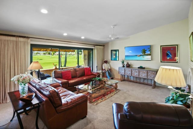 living room featuring light colored carpet, ceiling fan, and lofted ceiling