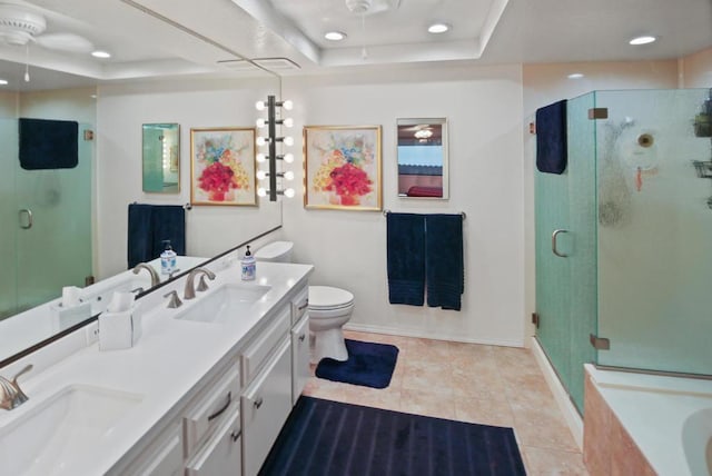 full bathroom with tile patterned floors, vanity, separate shower and tub, a raised ceiling, and toilet