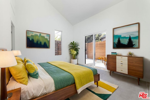 tiled bedroom featuring access to outside and high vaulted ceiling