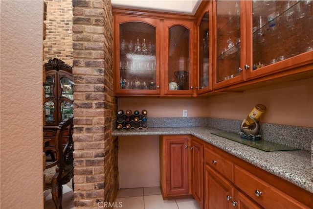 bar featuring light stone countertops and light tile patterned floors