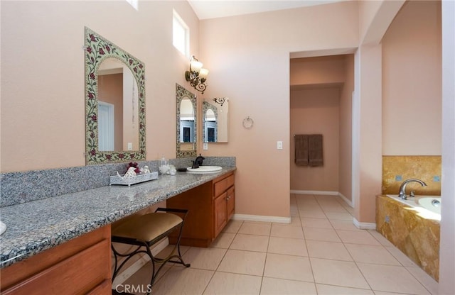 bathroom with tile patterned floors, tiled bath, and vanity