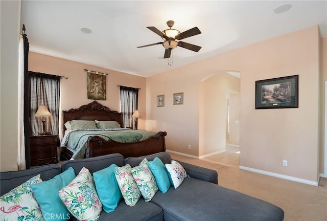 bedroom with ceiling fan and light carpet