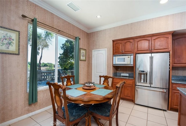 tiled dining room featuring ornamental molding