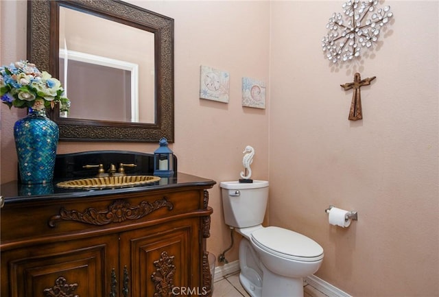 bathroom featuring tile patterned floors, vanity, and toilet