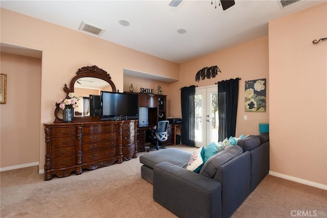 carpeted living room with french doors and ceiling fan