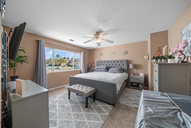 bedroom with ceiling fan and light carpet