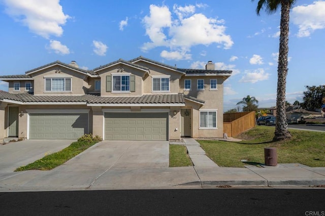 view of front of home with a front lawn and a garage