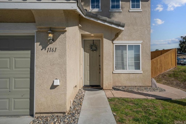 doorway to property featuring a garage