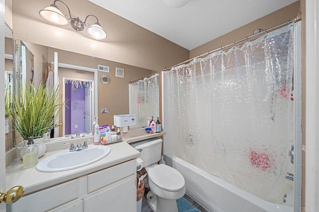 full bathroom with vanity, shower / tub combo, and toilet