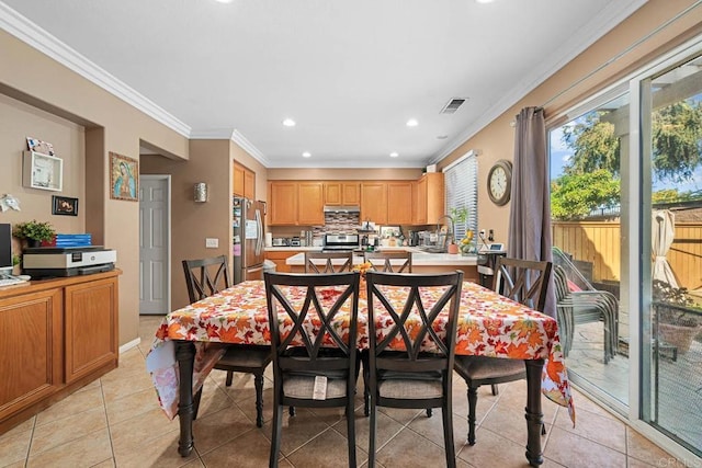 tiled dining area featuring ornamental molding