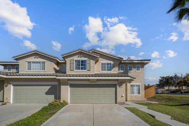 view of front of property with a garage and a front yard