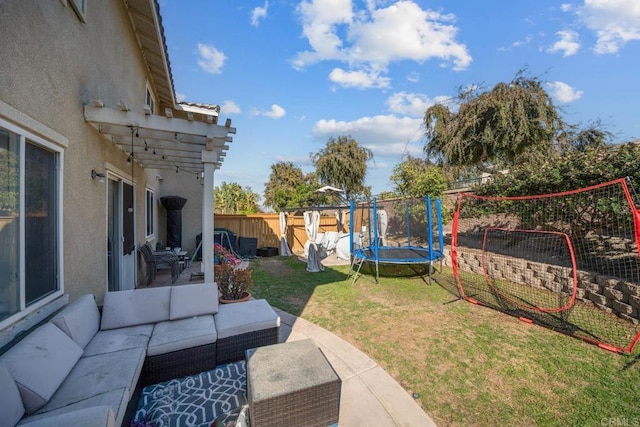 view of yard featuring outdoor lounge area, a trampoline, and a patio area