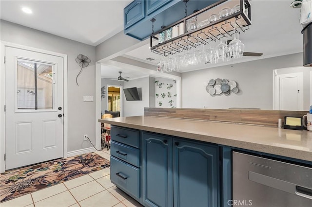 kitchen featuring ceiling fan, blue cabinets, and light tile patterned flooring