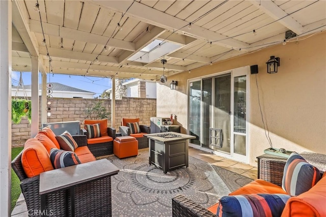 view of patio with an outdoor living space with a fire pit