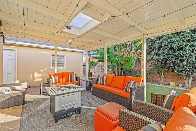 exterior space with beam ceiling, a skylight, and wooden ceiling