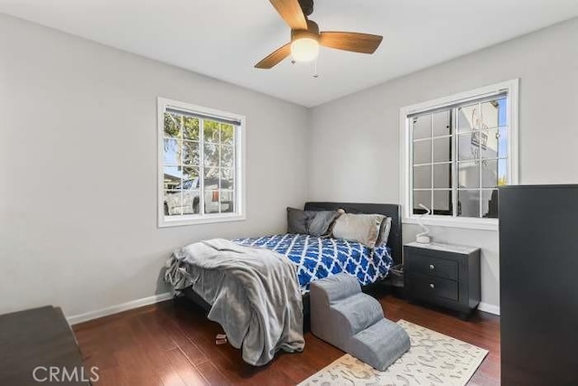 bedroom with dark wood-type flooring and ceiling fan