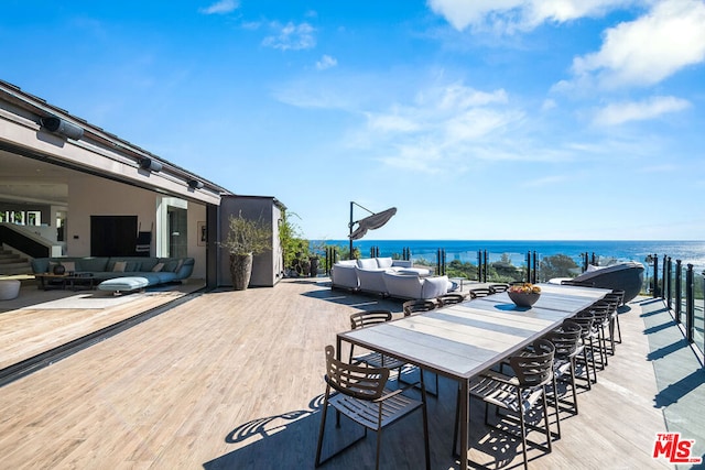 wooden terrace with outdoor lounge area and a water view