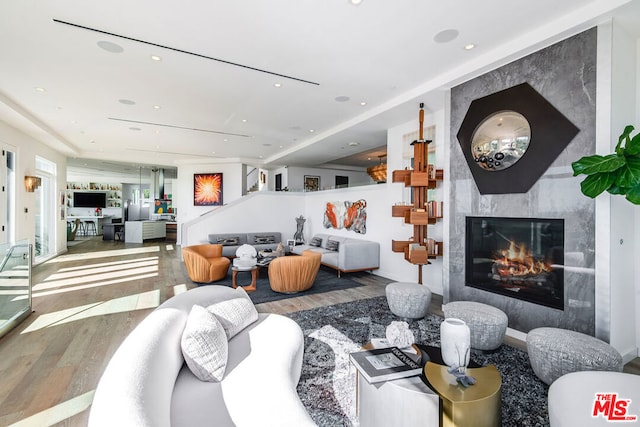 living room featuring hardwood / wood-style floors and a high end fireplace