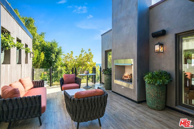 view of patio featuring an outdoor living space with a fireplace