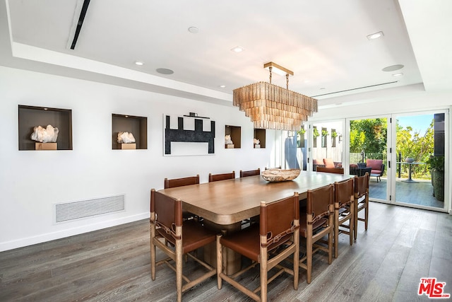 dining room with dark hardwood / wood-style floors, french doors, and a tray ceiling