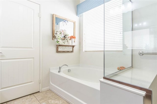 bathroom featuring a bath, tile patterned flooring, and a healthy amount of sunlight