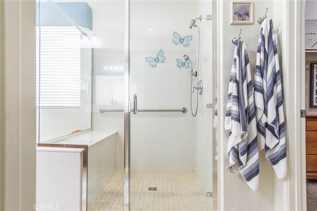 bathroom with tile patterned floors and an enclosed shower