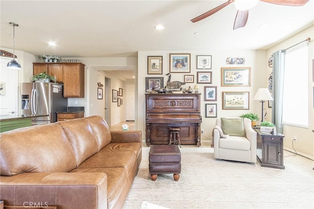 living room featuring light carpet and ceiling fan