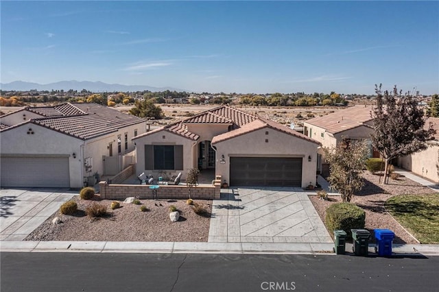 view of front of property with a mountain view and a garage